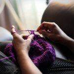 woman sewing purple textile